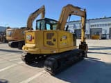 2022 Caterpillar 310 crawler excavator, rear three-quarter view
