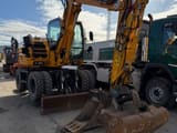 2012 New Holland MH 2.6 wheel excavator, front three-quarter view