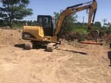 2020 Caterpillar 305.5 mini excavator, rear three-quarter view