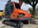 2024 Doosan DX75-9C mini excavator, rear three-quarter view
