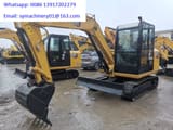 2023 Caterpillar 305.5E2 mini excavator, front three-quarter view