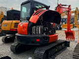 2023 Kubota KX165 mini excavator, front three-quarter view with engine cover open
