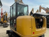 2024 Caterpillar 305.5E2 mini excavator, rear three-quarter view