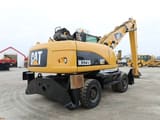 2008 Caterpillar M322D material handler, rear three-quarter view