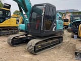 2024 Kobelco SK140 crawler excavator, front three-quarter view