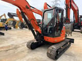 2022 Kubota KX057-4 mini excavator, front three-quarter view