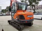 2022 Doosan DX55-9C mini excavator, rear three-quarter view