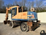 1997 Caterpillar M315 wheel excavator rear three-quarter view