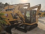 2026 Caterpillar 305.5 mini excavator, front three-quarter view