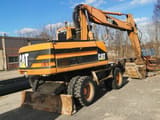 2001 Caterpillar M318 wheel excavator, rear three-quarter view