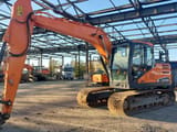 Doosan DX140LC-5 crawler excavator, side view