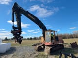 1977 Åkerman H12B excavator, side view with grapple attachment