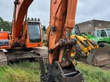 2009 Doosan DX255LC crawler excavator, front view of boom and attachment