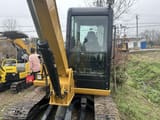 Caterpillar 306 mini excavator, front view of cab and boom