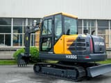 2026 Hyundai HX60G mini excavator, rear three-quarter view