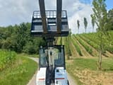 2022 Bobcat L28E mini excavator, front view with pallet forks