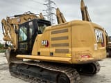 2018 Caterpillar 320 excavator, rear three-quarter view