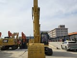 2020 Caterpillar 320BL crawler excavator, front view with boom raised