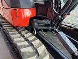 2021 Kubota KX080-4A2 mini excavator side view of the undercarriage and boom base