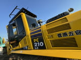 2022 Komatsu PC210LC excavator cab and engine housing side view