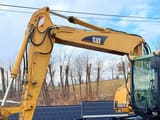 2003 Caterpillar M315C wheel excavator boom and cab side view