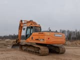 Doosan DX225LC crawler excavator, rear three-quarter view