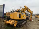 2006 New Holland E135SR-1ES crawler excavator, rear three-quarter view