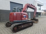 2005 New Holland E70 mini excavator, rear three-quarter view