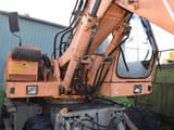 1990 O&K MH 5 wheel excavator, close-up of cab and boom