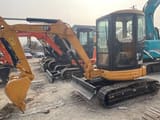 2025 Caterpillar 303.5 mini excavator, front three-quarter view