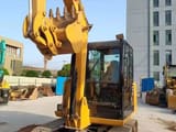 2024 Caterpillar 305.5E2 mini excavator, front three-quarter view