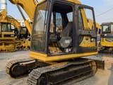 2024 Komatsu PC60 excavator, side view of cab and tracks