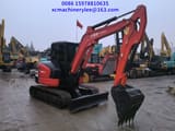 2023 Kubota KX057-4 mini excavator, side view