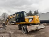 2011 Caterpillar M313D wheel excavator, rear three-quarter view