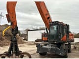 2022 Doosan DX250WMH-7 wheel excavator with grapple attachment, side view