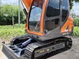2024 Doosan DX75-9C mini excavator, front three-quarter view