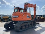 2015 Doosan DX140LCR crawler excavator, rear three-quarter view