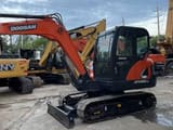 2023 Doosan DX55-9C mini excavator, front three-quarter view