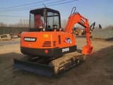 2023 Doosan DH55 mini excavator, rear three-quarter view