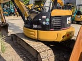 2023 Caterpillar 304CR mini excavator, rear three-quarter view