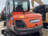 2023 Doosan DX60-9C mini excavator, rear three-quarter view