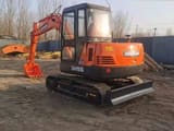 2023 Doosan DH55 mini excavator, rear three-quarter view