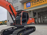 2024 Doosan DX225LCA crawler excavator, front three-quarter view