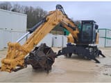 2021 Caterpillar MH3022-07 wheel excavator, front three-quarter view