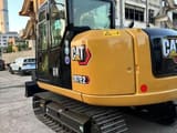 2023 Caterpillar 307E2 mini excavator, rear three-quarter view