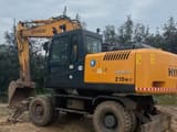 Hyundai Robex 210W-7 wheel excavator, rear three-quarter view