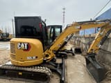 2024 Caterpillar 303.5E mini excavator, rear three-quarter view
