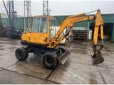 1990 Komatsu PW30-1 wheel excavator, front three-quarter view