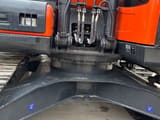 2023 Doosan DX225LC-9C crawler excavator, close-up of the swing bearing and undercarriage