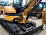 2024 Caterpillar 304 mini excavator, front three-quarter view